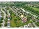 Aerial view of a home showcasing the backyard, deck, mature trees, and surrounding neighborhood at 13757 Flintridge Pass, Carmel, IN 46033