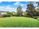 Spacious backyard featuring a well-maintained lawn, mature trees, and a wooden fence for privacy at 13757 Flintridge Pass, Carmel, IN 46033