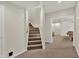 Finished basement entrance featuring carpeted stairs and an open doorway to the recreation area at 13757 Flintridge Pass, Carmel, IN 46033