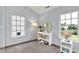 Bright bedroom featuring a makeup vanity, a large window, and neutral paint at 13757 Flintridge Pass, Carmel, IN 46033