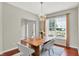 Inviting dining room featuring a wooden table with gray chairs and stylish light fixture at 13757 Flintridge Pass, Carmel, IN 46033