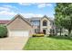 Beautiful two-story brick home featuring a manicured lawn and attached two-car garage at 13757 Flintridge Pass, Carmel, IN 46033