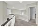 Hallway with carpet, ceiling fan, and views of open doorways at 13757 Flintridge Pass, Carmel, IN 46033