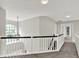 Upstairs hallway with black and white banister and pendant light feature at 13757 Flintridge Pass, Carmel, IN 46033