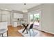 Bright kitchen with a breakfast nook, white cabinets, and access to the deck at 13757 Flintridge Pass, Carmel, IN 46033