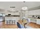 Eat-in kitchen with stainless steel appliances, breakfast bar, and modern lighting fixtures at 13757 Flintridge Pass, Carmel, IN 46033