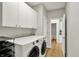 Convenient laundry room with new washer and dryer, storage cabinets, and tile flooring at 13757 Flintridge Pass, Carmel, IN 46033