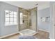 Corner shower featuring glass surround, tiled wall, tiled niche, and a shower head at 13757 Flintridge Pass, Carmel, IN 46033