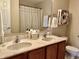Bathroom featuring a double sink vanity with neutral decor, tile floors, and decorative items at 13859 Keams Dr, Fishers, IN 46038