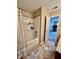 Bathroom with a shower-tub combo, neutral decor, and tile flooring at 13859 Keams Dr, Fishers, IN 46038