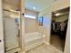 Bathroom with a soaking tub, glass enclosed shower, tile floors and a walk-in closet at 13859 Keams Dr, Fishers, IN 46038