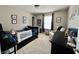 Bedroom featuring a toddler bed, neutral paint and decor, and a rocking chair at 13859 Keams Dr, Fishers, IN 46038