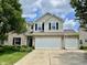Charming two-story home features brick and vinyl siding, dark shutters, and a spacious three-car garage at 13859 Keams Dr, Fishers, IN 46038