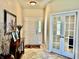 Inviting foyer with white front door and glass paneled french doors at 13859 Keams Dr, Fishers, IN 46038