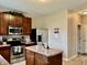 The kitchen features stainless appliances, wood cabinets and a functional center island at 13859 Keams Dr, Fishers, IN 46038