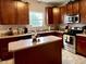 This well-appointed kitchen has an island, wood cabinets, and stainless steel appliances at 13859 Keams Dr, Fishers, IN 46038