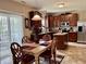 Eat-in kitchen with wood cabinets, stainless appliances and dining table with seating for four at 13859 Keams Dr, Fishers, IN 46038