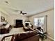 Inviting living room features neutral paint, ceiling fan, and large windows at 13859 Keams Dr, Fishers, IN 46038