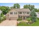 A beautiful home with a large yard and mature trees, showcasing its curb appeal and setting at 1393 Turfway Dr, Avon, IN 46123