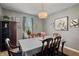 Elegant dining room with stylish chandelier, seating for six, and soft natural light from the window at 1393 Turfway Dr, Avon, IN 46123