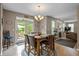 Open dining area features a large table, hardwood floors, chandelier, and access to the outdoor patio area at 1393 Turfway Dr, Avon, IN 46123