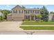 Charming two-story home with a well-manicured lawn, three-car garage, and lovely front porch at 1393 Turfway Dr, Avon, IN 46123