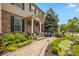 Landscaped front yard with stone walkway leading to a covered porch with seating and decorative plants at 1393 Turfway Dr, Avon, IN 46123