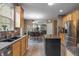 Open kitchen offers stainless appliances, granite counters, an island, flowing into dining area for easy entertaining at 1393 Turfway Dr, Avon, IN 46123
