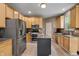 Functional kitchen equipped with stainless steel appliances, granite countertops, ample cabinet space, and a central island at 1393 Turfway Dr, Avon, IN 46123