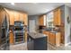 Bright kitchen boasts stainless steel appliances, granite counters, a central island, and abundant cabinet space at 1393 Turfway Dr, Avon, IN 46123