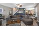 Comfortable living room with a large sectional, a modern ceiling fan, and an open view to the kitchen at 1393 Turfway Dr, Avon, IN 46123