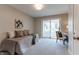 Bright bedroom features neutral walls, carpet, sliding glass door, daybed and desk with chair at 14407 Bryn Mawr Dr, Fishers, IN 46038