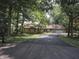 Scenic home exterior with a long driveway, mature trees, and a combination of stone and siding at 14407 Bryn Mawr Dr, Fishers, IN 46038