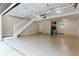 Large, bright garage features epoxy flooring, neutral walls, stairs to upper level, and plenty of storage at 14407 Bryn Mawr Dr, Fishers, IN 46038