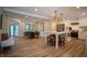 Open-concept kitchen featuring an island with bar seating, stainless appliances, and an adjacent dining area at 14407 Bryn Mawr Dr, Fishers, IN 46038