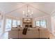Inviting living room featuring a stone fireplace, vaulted ceilings, and abundant natural light at 14407 Bryn Mawr Dr, Fishers, IN 46038