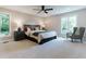 Bright and airy main bedroom with large windows, carpeted floors, and a wooden headboard at 14407 Bryn Mawr Dr, Fishers, IN 46038