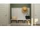 Inviting mudroom features built-in bench with storage baskets, hat, and coat hooks near the front door at 15389 Manderley St, Fishers, IN 46040