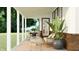 Charming covered patio featuring comfortable seating, a dining area, and potted plants at 15424 Manderley St, Fishers, IN 46040
