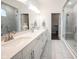 Bright bathroom featuring double sinks, white countertops, and a glass-enclosed shower with a built-in bench at 1580 Mairn Ave, Carmel, IN 46032