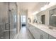 Spacious primary bathroom with double vanities, glass-enclosed shower, and neutral tile, providing a spa-like experience at 1580 Mairn Ave, Carmel, IN 46032