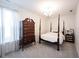 Cozy bedroom with a four-poster bed, dresser, and a chandelier at 1580 Mairn Ave, Carmel, IN 46032