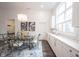 Dining area features stylish lighting, large window for lots of light and seamless flow to kitchen at 1580 Mairn Ave, Carmel, IN 46032