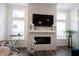 Elegant fireplace with marble surround, TV, and stylish decor in a bright living room at 1580 Mairn Ave, Carmel, IN 46032