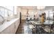 Open-concept kitchen and dining area with stylish island, stainless steel appliances, and modern lighting fixtures at 1580 Mairn Ave, Carmel, IN 46032