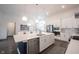 Modern kitchen boasts stainless steel appliances, and a large center island with a sink at 1580 Mairn Ave, Carmel, IN 46032