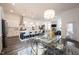 Spacious kitchen with island, pendant lighting, and a dining area featuring elegant chandelier and seating for Gathering at 1580 Mairn Ave, Carmel, IN 46032