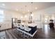 Modern kitchen boasts stainless steel appliances, a large center island with seating, and stylish pendant lighting at 1580 Mairn Ave, Carmel, IN 46032