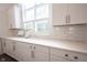 Bright kitchen featuring white cabinetry, quartz countertops, subway tile backsplash, and natural light from a window at 1580 Mairn Ave, Carmel, IN 46032