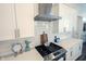 Gourmet kitchen features stainless steel appliances, quartz countertops, tile backsplash, and gas cooktop at 1580 Mairn Ave, Carmel, IN 46032